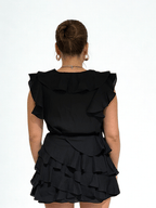 Black ruffle mini set by Chez Neeba, sleeveless top and layered mini skirt, limited edition Dubai women’s fashion.