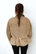Desert Dusk Jacket by Chez Neeba — sophisticated neutral jacket with a darker olive leather collar and ruffled back detailing, crafted from premium textured fabric for a modern, feminine, and effortlessly elegant silhouette.