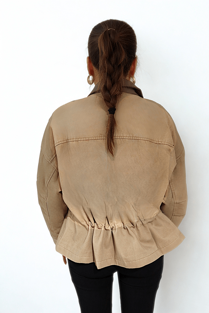 Desert Dusk Jacket by Chez Neeba — sophisticated neutral jacket with a darker olive leather collar and ruffled back detailing, crafted from premium textured fabric for a modern, feminine, and effortlessly elegant silhouette.
