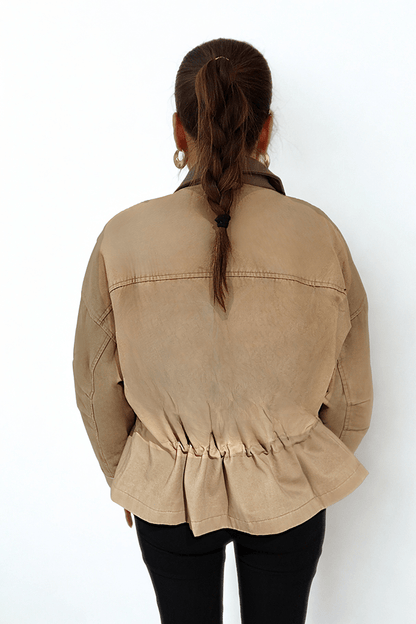 Desert Dusk Jacket by Chez Neeba — sophisticated neutral jacket with a darker olive leather collar and ruffled back detailing, crafted from premium textured fabric for a modern, feminine, and effortlessly elegant silhouette.