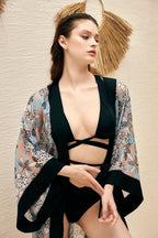 Discover the Serene Bloom Kimono by Chez Neeba — pastel floral chiffon kimono with black trim, designed for effortless elegance.