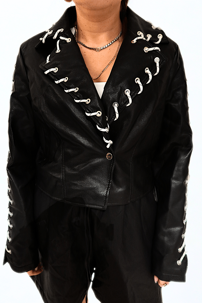 Cropped black leather jacket with white rope lace-up details by Chez Neeba, exclusive Dubai fashion piece.