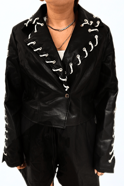 Cropped black leather jacket with white rope lace-up details by Chez Neeba, exclusive Dubai fashion piece.