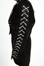 Model wearing The Edge-Laced Jacket by Chez Neeba — cropped black leather jacket with white lace-up detailing, limited edition Dubai fashion.