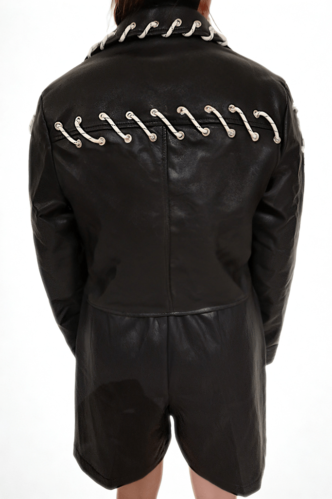 Model wearing The Edge-Laced Jacket by Chez Neeba — cropped black leather jacket with white lace-up detailing, limited edition Dubai fashion.