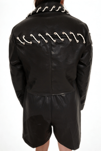 Model wearing The Edge-Laced Jacket by Chez Neeba — cropped black leather jacket with white lace-up detailing, limited edition Dubai fashion.