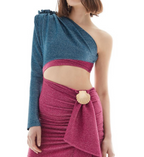 Woman wearing a blue and pink dress with a shell detail on a white background