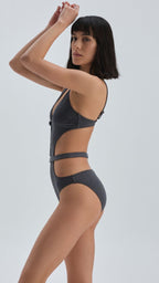 Woman wearing a dark gray bikini set on a white background